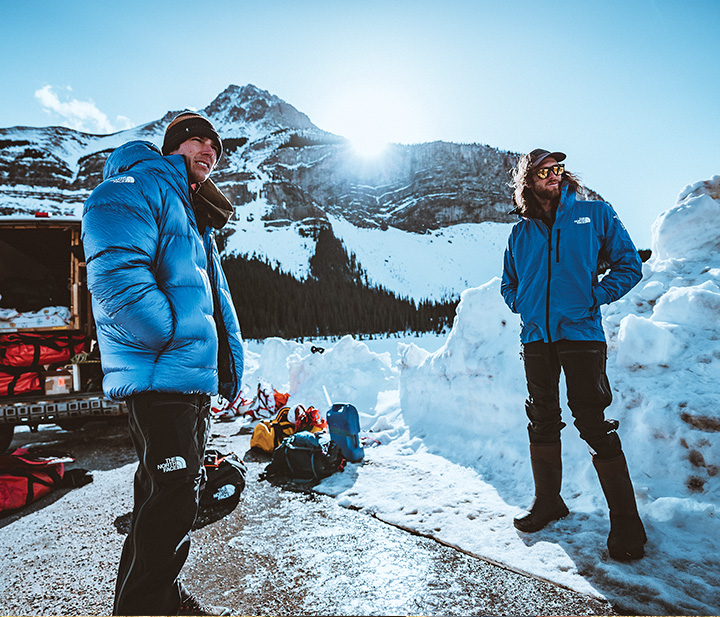 Two men in an extreme winter environment wearing custom The North Face Jackets available at Maverick Printing in Reno.