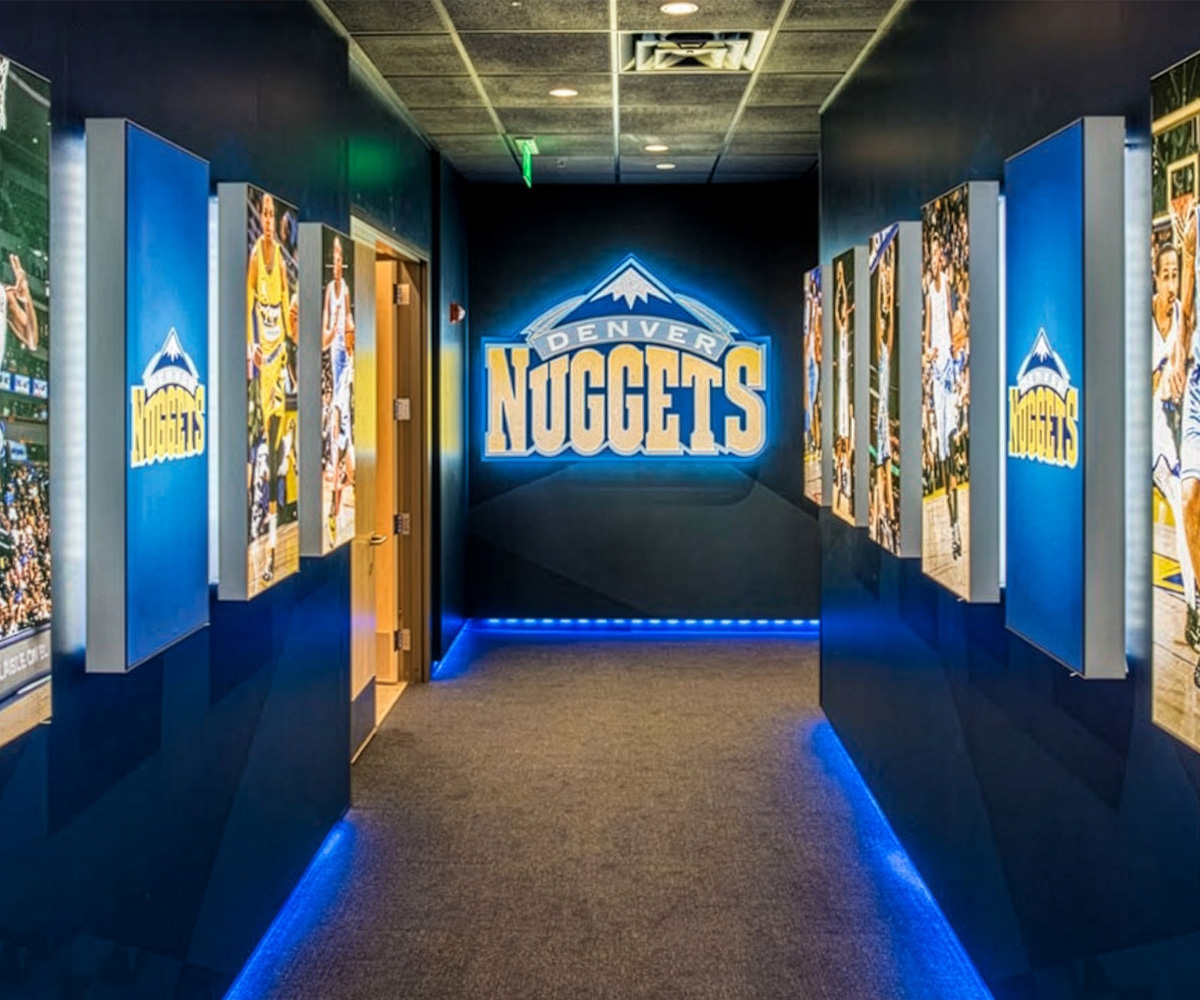 Colorful backlit graphics lining the halls of a corporate, sports environment.
