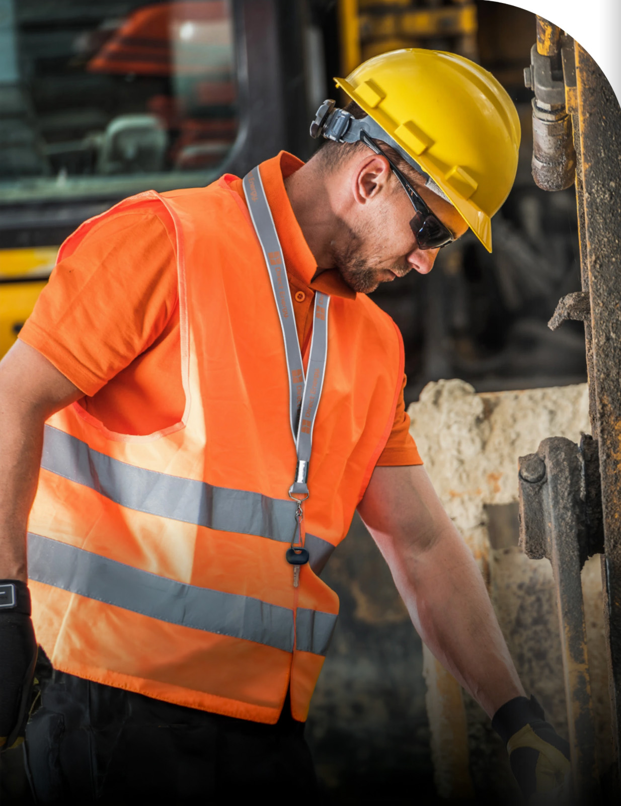 Industrial lanyard word by person wearing yellow hard hat and orange high vis vest.